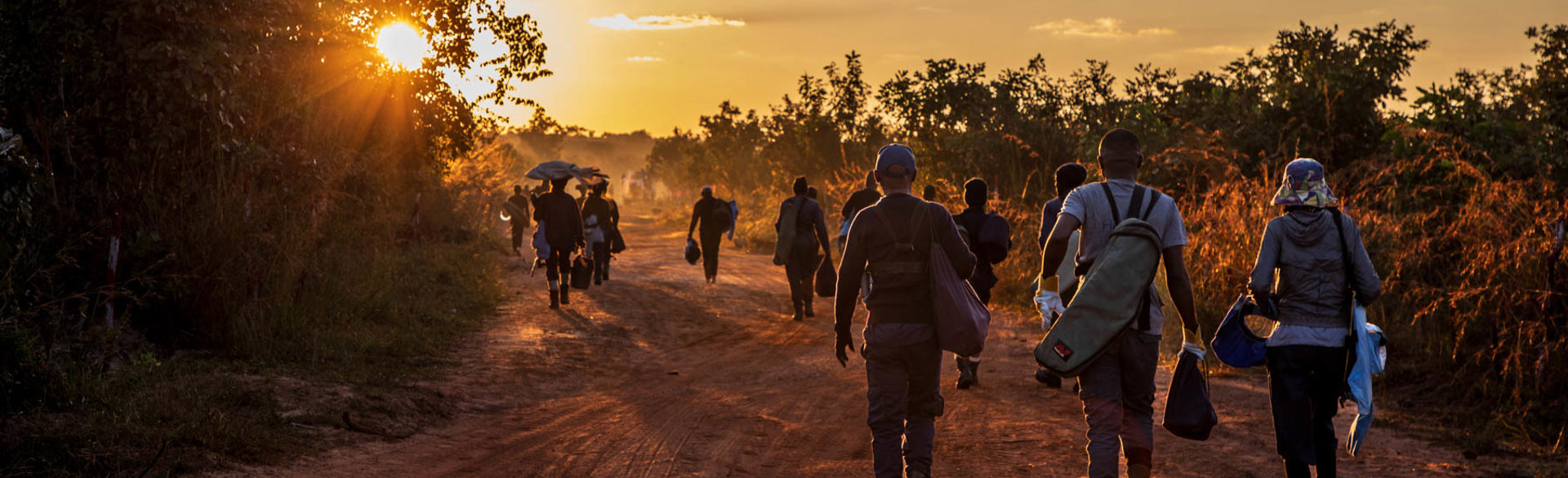 HALO Trust deminers walk home after work in Lusserei, Angola