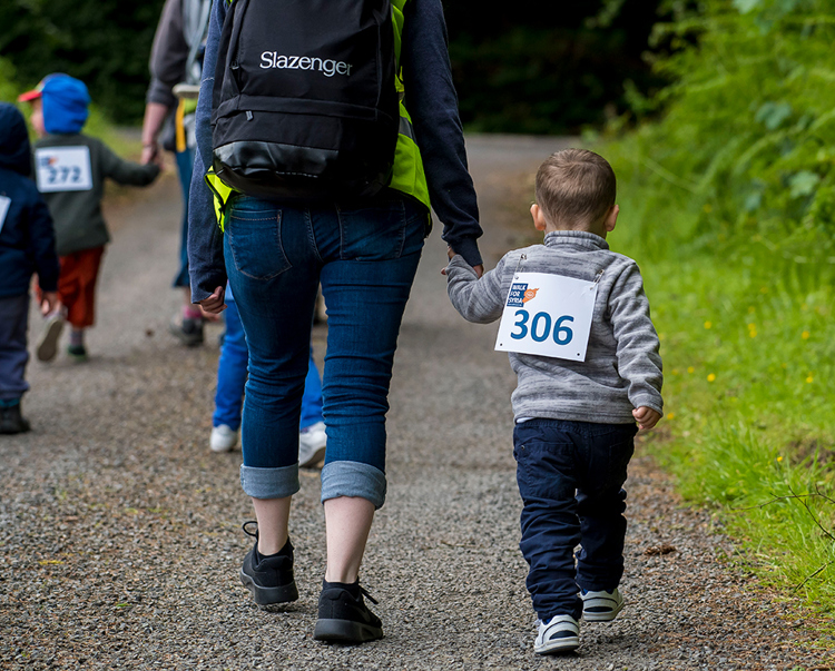 Children hold onto adults hands as they "walk for Syria"