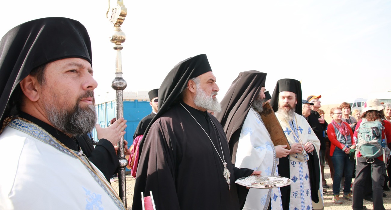 Clergy lead a solemn procession during the epiphany service at the Baptism site, dressed in traditional robes.