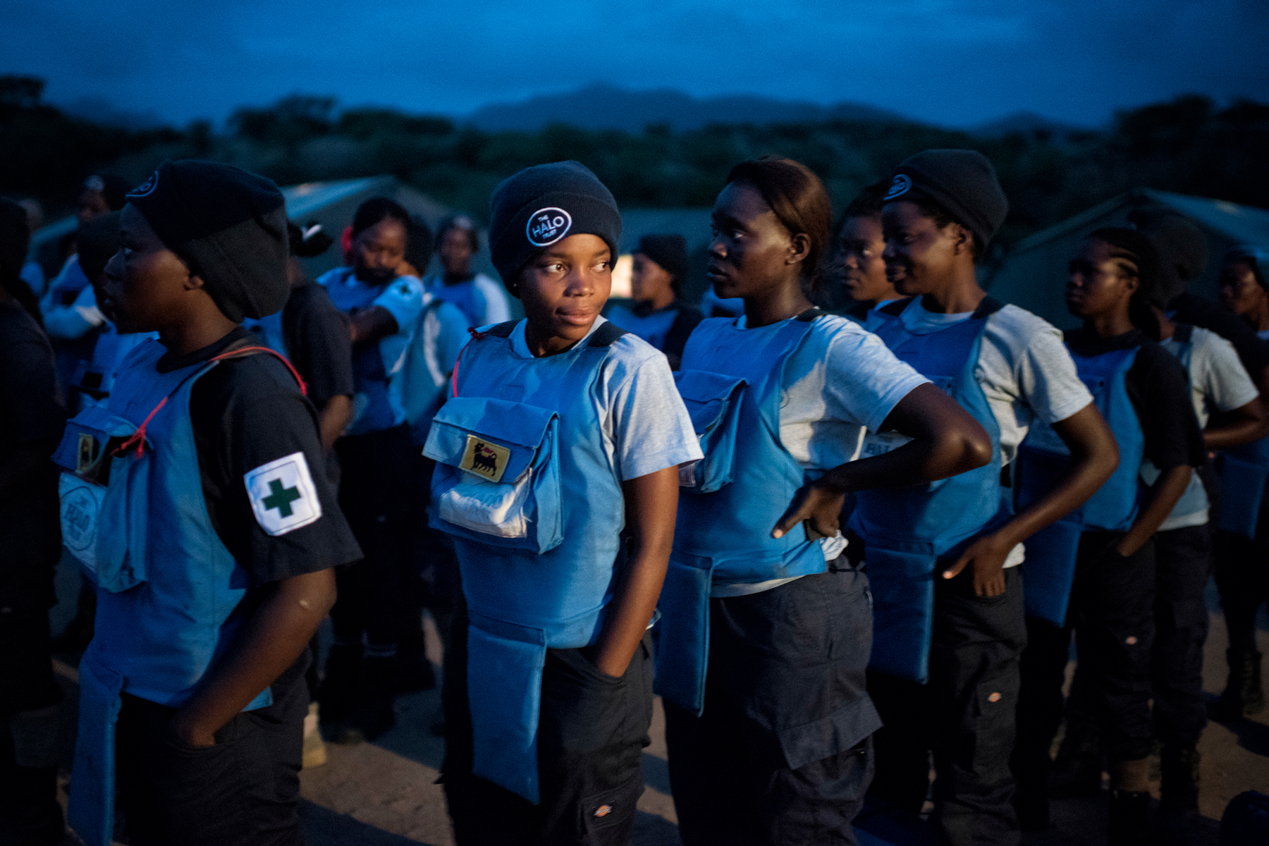 A female demining team prepare for the morning parade in the early hours in Angola