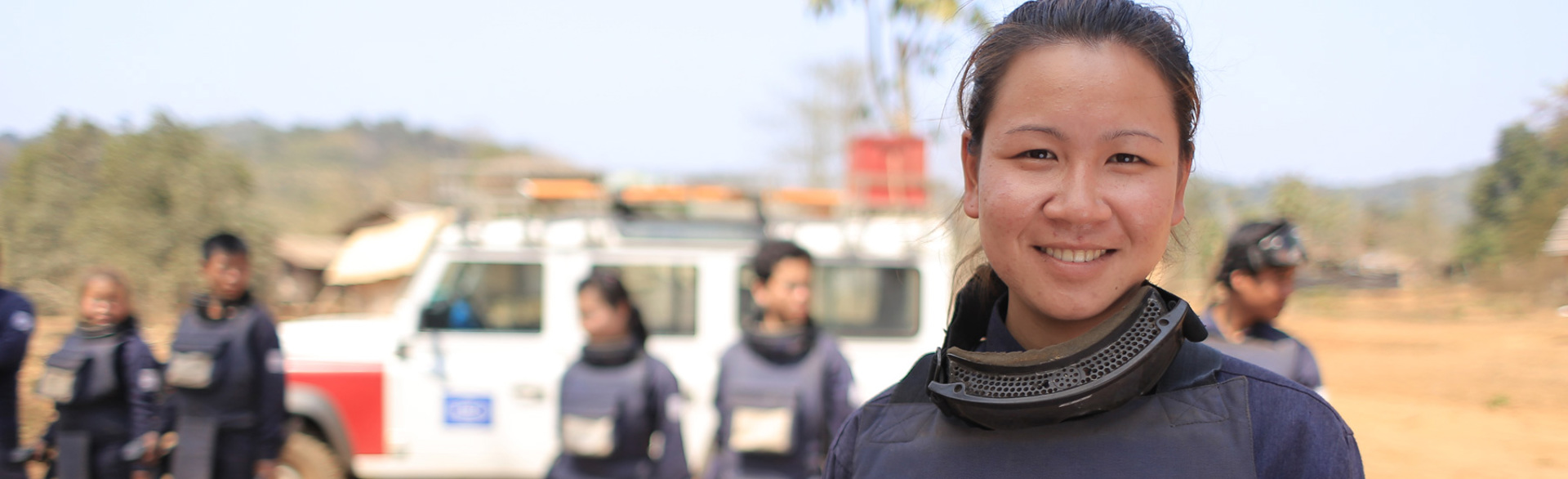 HALO Trust team leader in Cambodia standing on a minefield with the local team