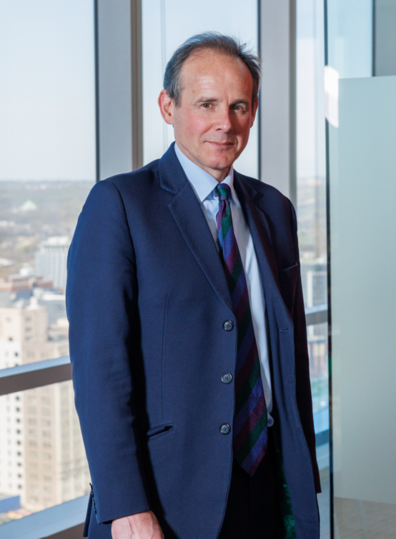 HALO CEO James Cowan stands in front of an urban tower's window