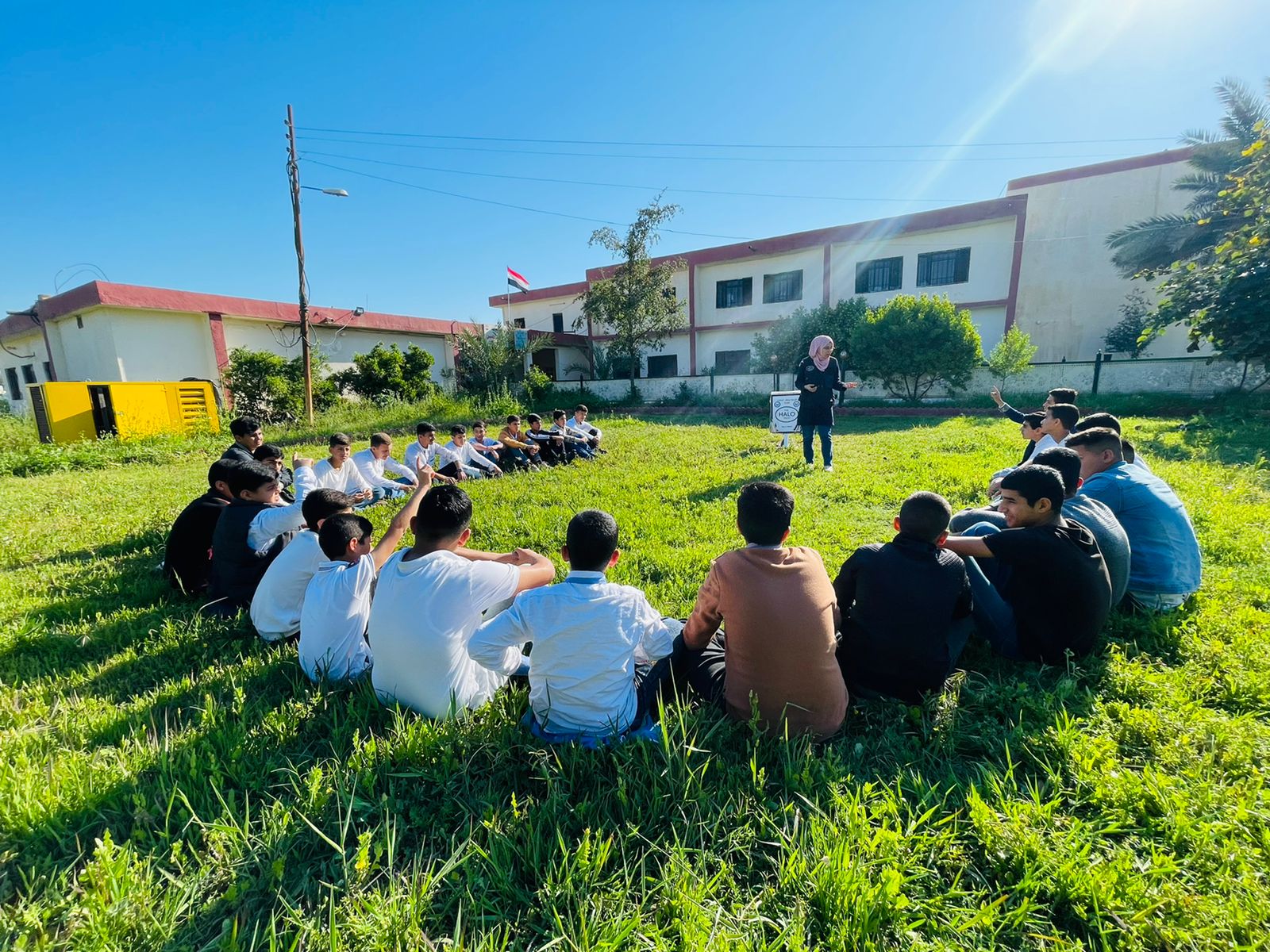 HALO staff member gives safety training to a group of children in Iraq