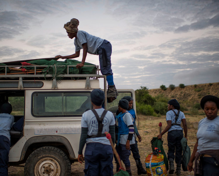 Female deminers load a land rover in Angola
