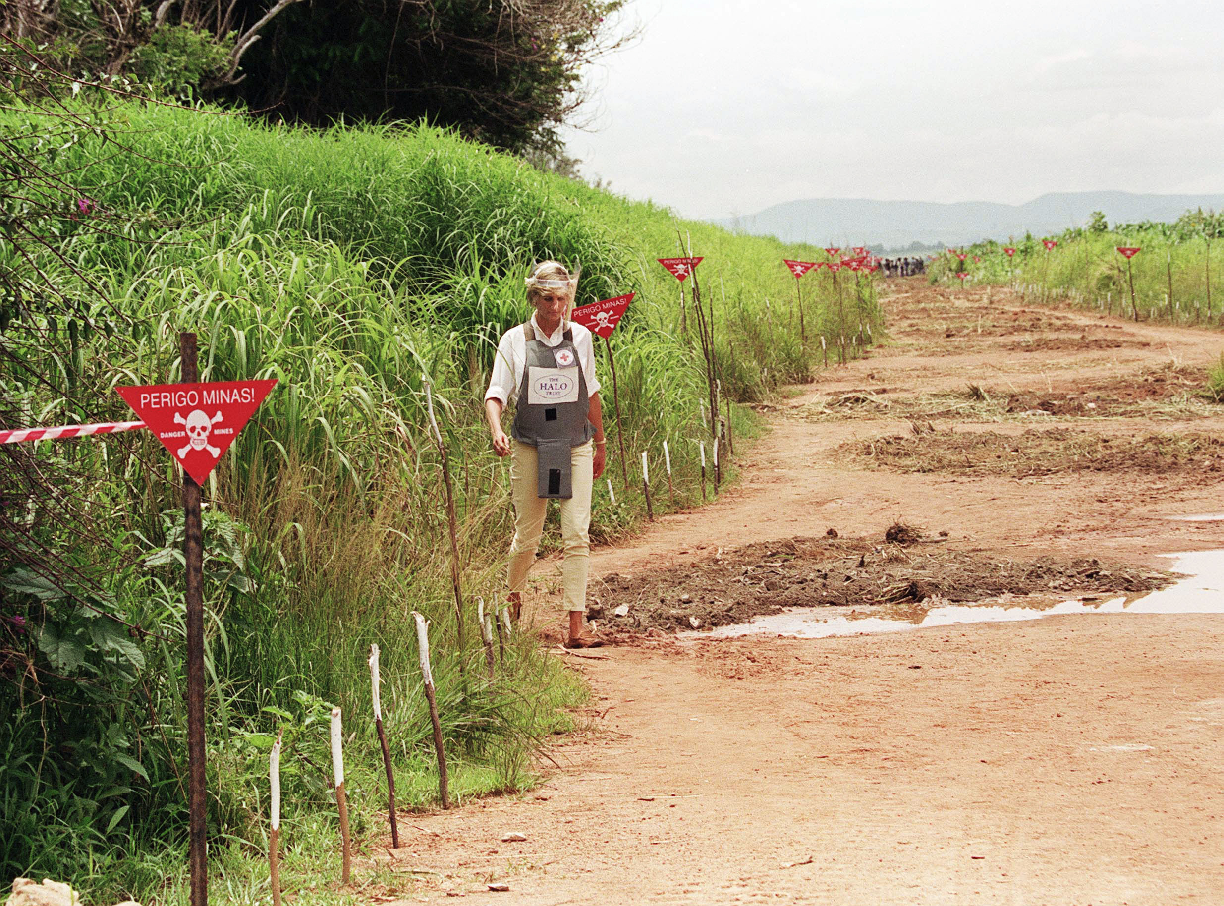 Princess Diana walking through a minefield in Angola in 1997