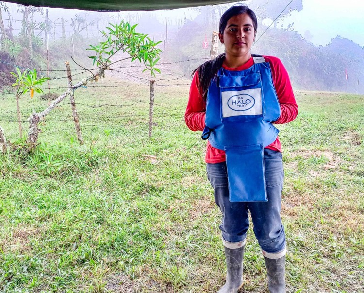 Nuss Perdomo, a deminer in Colombia, stands in a field