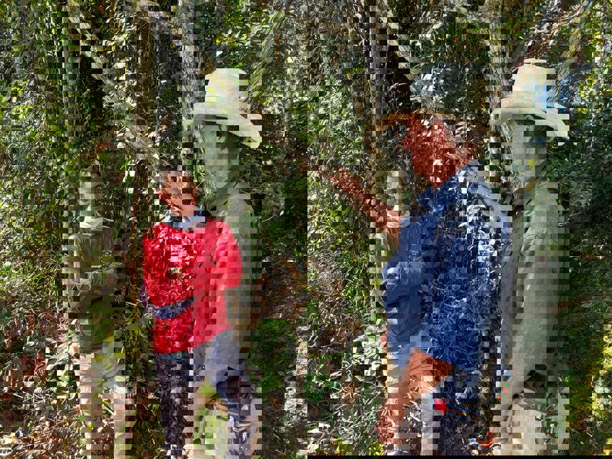 A Colombian HALO staff member speaks with a man wearing a hat outside