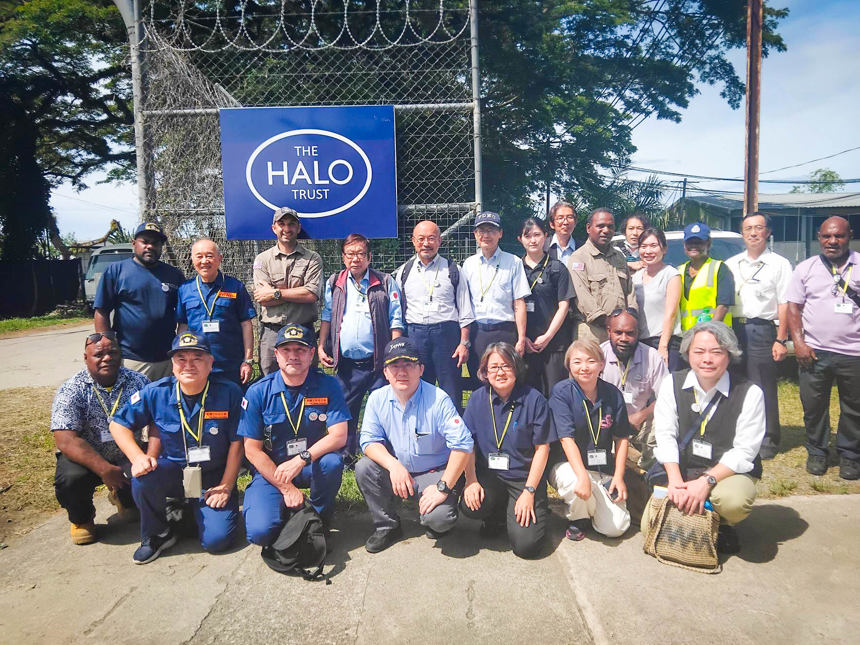 HALO and volunteers from JARRWC pose outside in front of the HALO logo