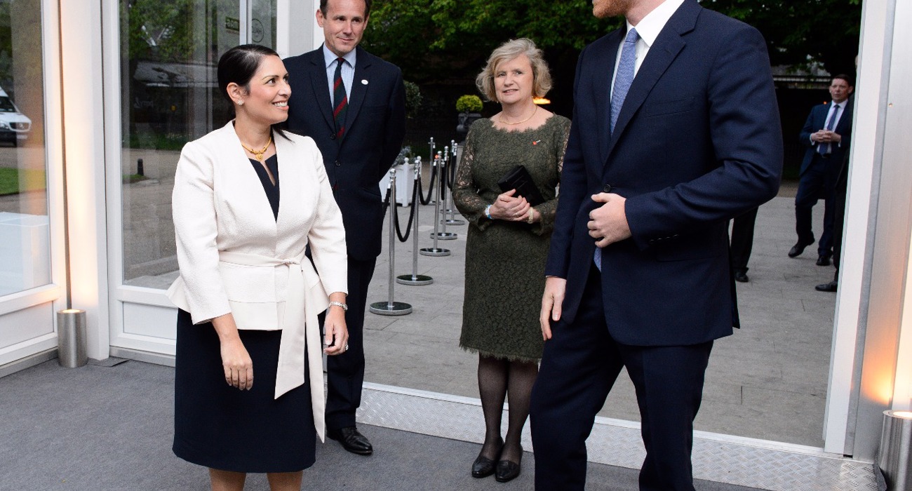 Former Secretary of State for International Development, Priti Patel talks with Prince Harry