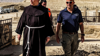 The head of the Franciscan Mission in Jerusalem visits their churchyard at the Baptism site of Christ.