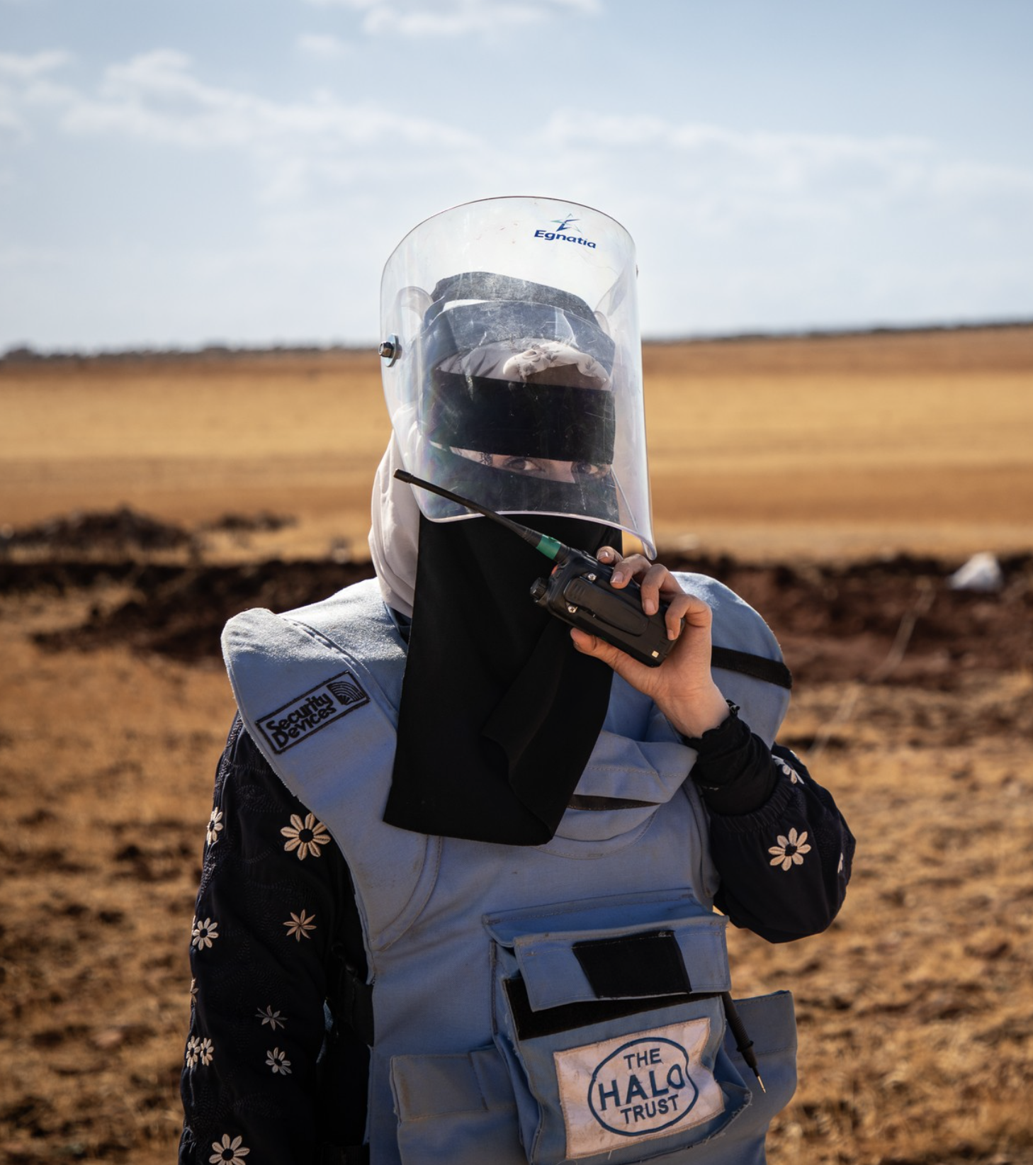 HALO woman deminer wearing PPE on a minefield in Syria