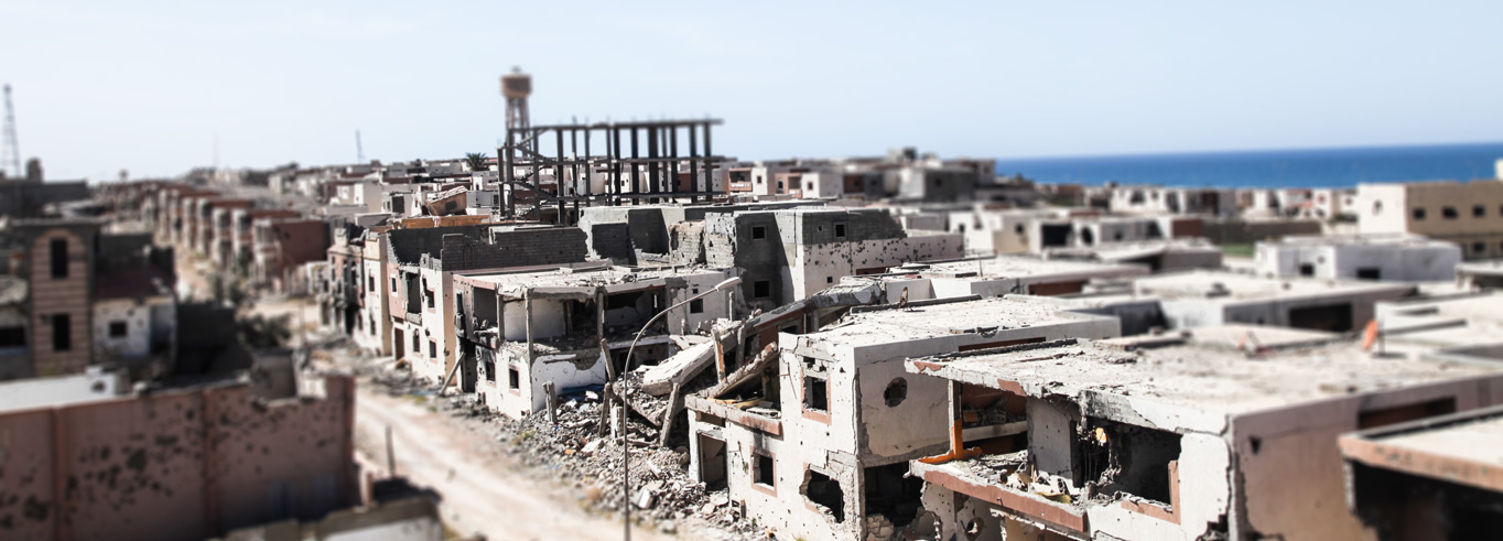 Bombed houses and buildings on a street in Sirte, Libya