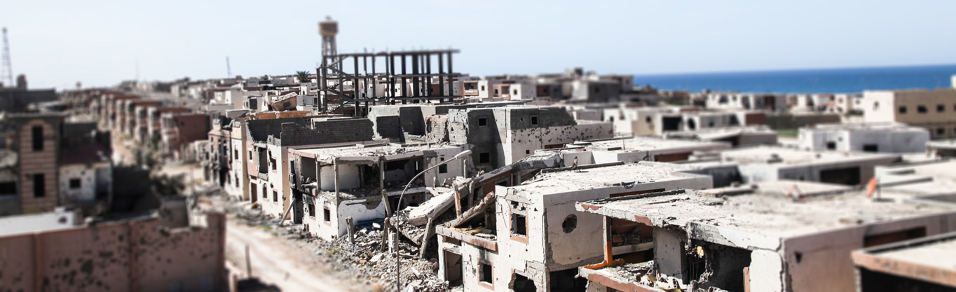 Bombed houses and buildings on a street in Sirte, Libya