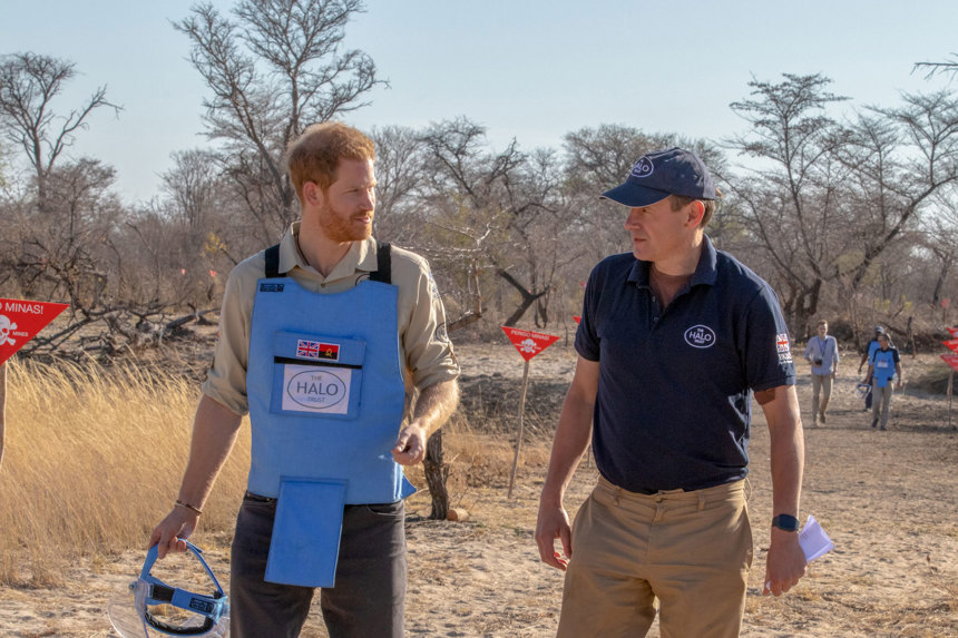Prince Harry wears a protective vest whilst walking through a minefield with HALO Trust CEO, James Cowan