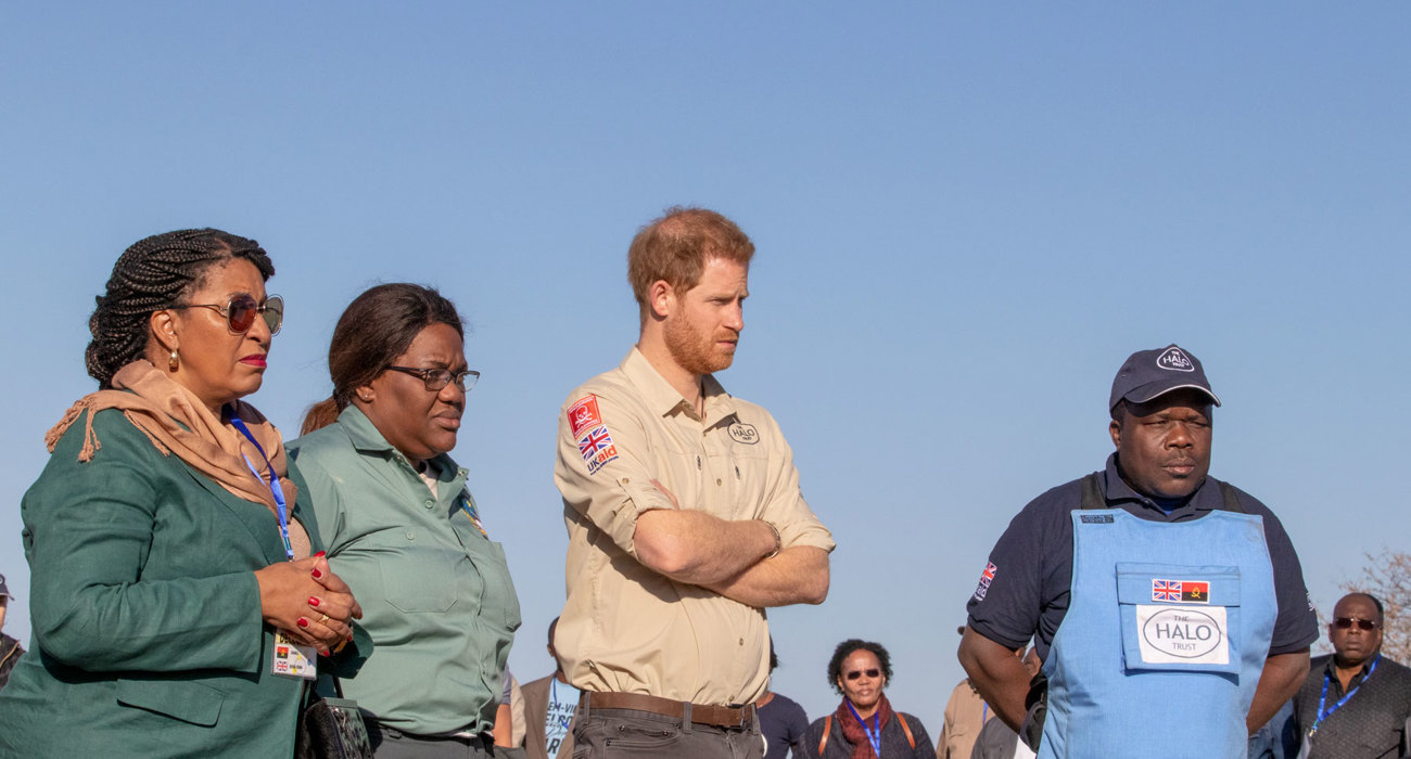 Prince Harry and officials receive a briefing in a minefield in Angola