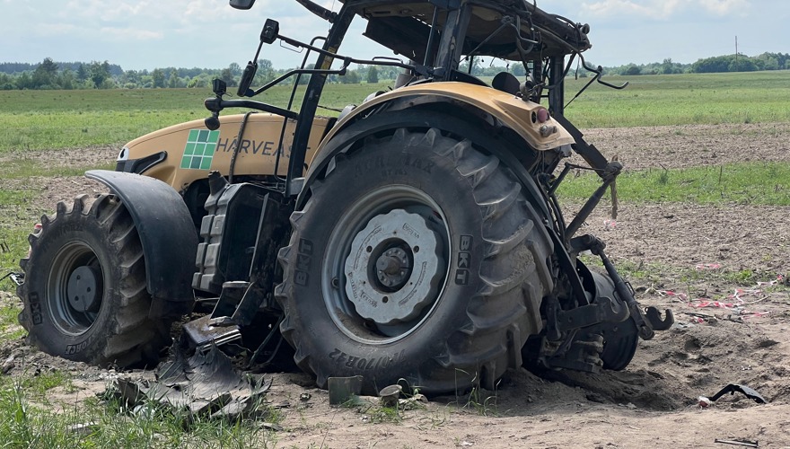 A blown-up tractor sits in a field in Ukraine 