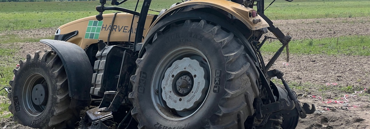 A blown-up tractor sits in a field in Ukraine