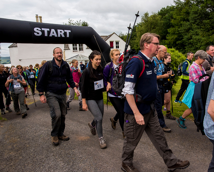 A group participating in the "walk for Syria" event take off from the start line