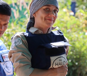 Woman smiling, wearing a HALO vest