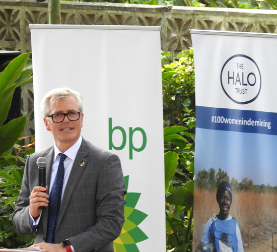 Stephen Willis delivers speech standing in front of BP and HALO banners