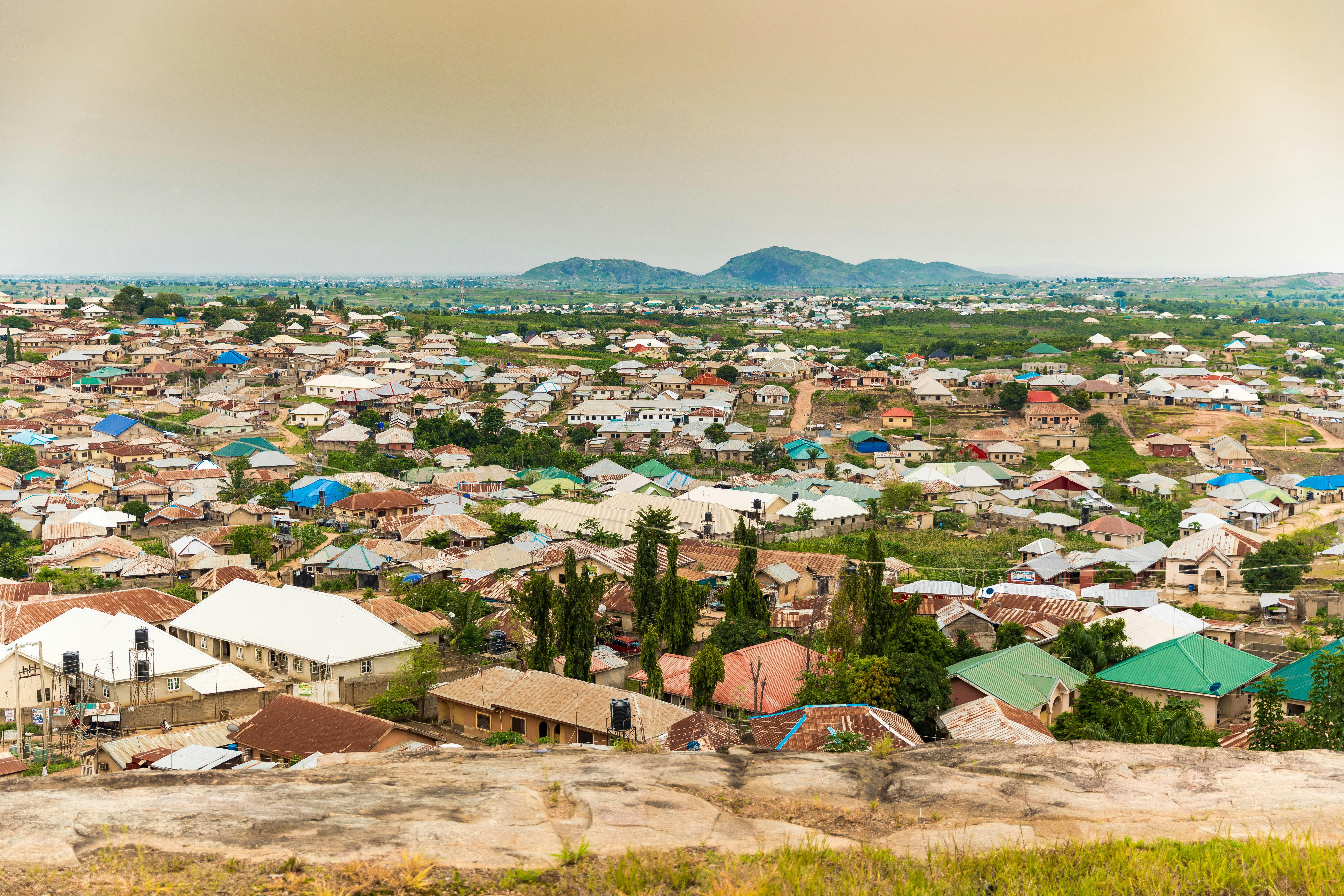 Nigerian homes with plains and hills behind