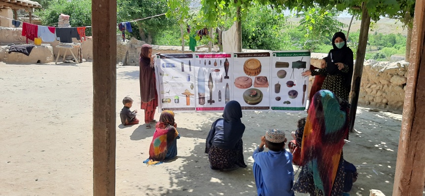 A female HALO Trust team member delivers an explosive ordnance risk education session to children in Pacheer Village, Afghanistan