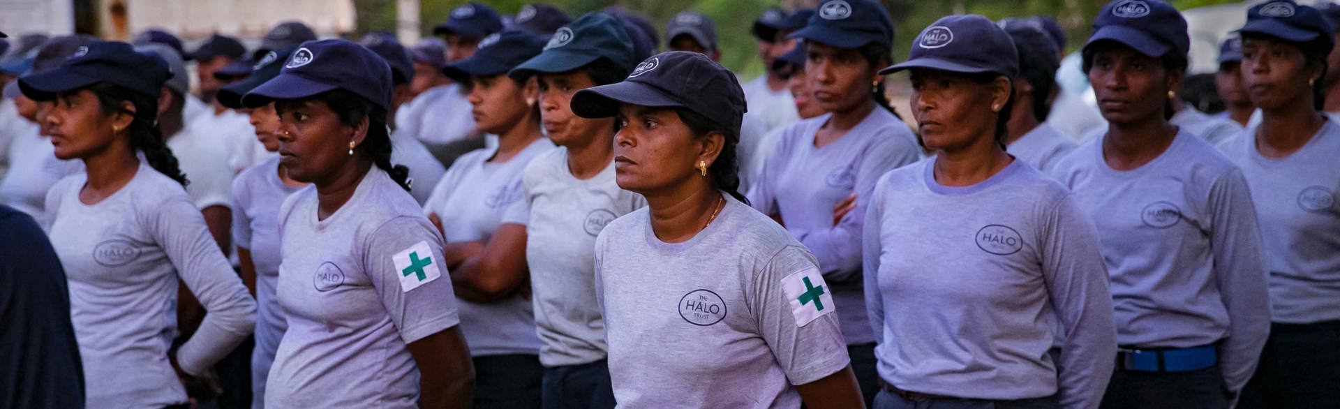 HALO female staff members stand in line outside