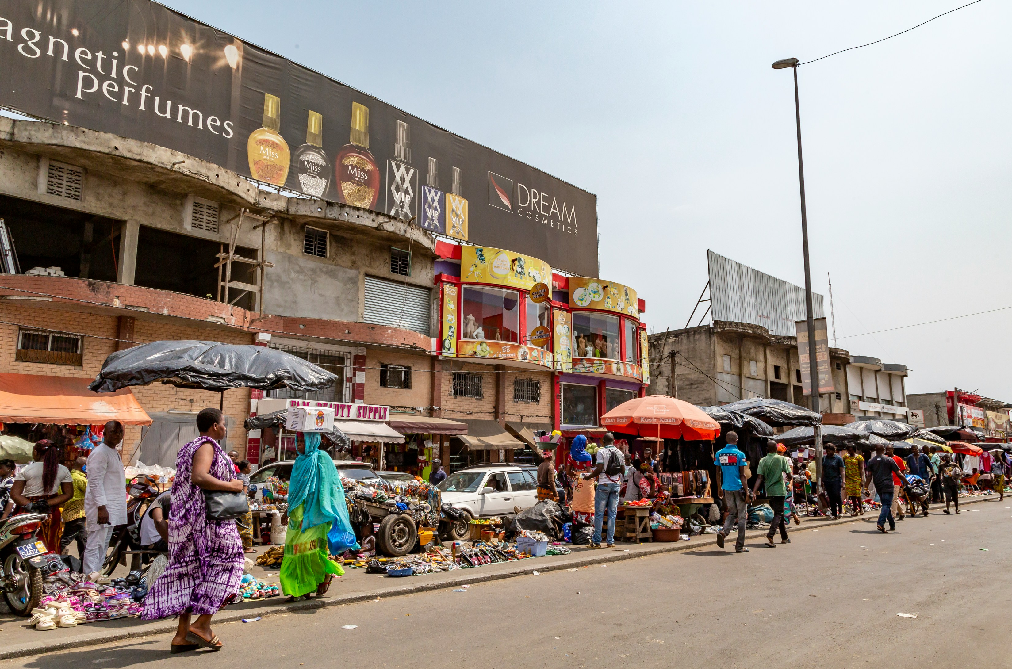 People walking along a street market in Cote d'Ivoire