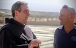 The head of the Franciscan Mission talks with a HALO Trust staff member following the removal of landmines from the compound