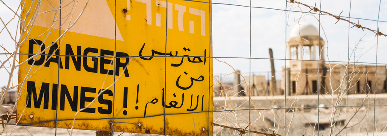A danger mines sign on a fence outside the site of the Baptism of Christ