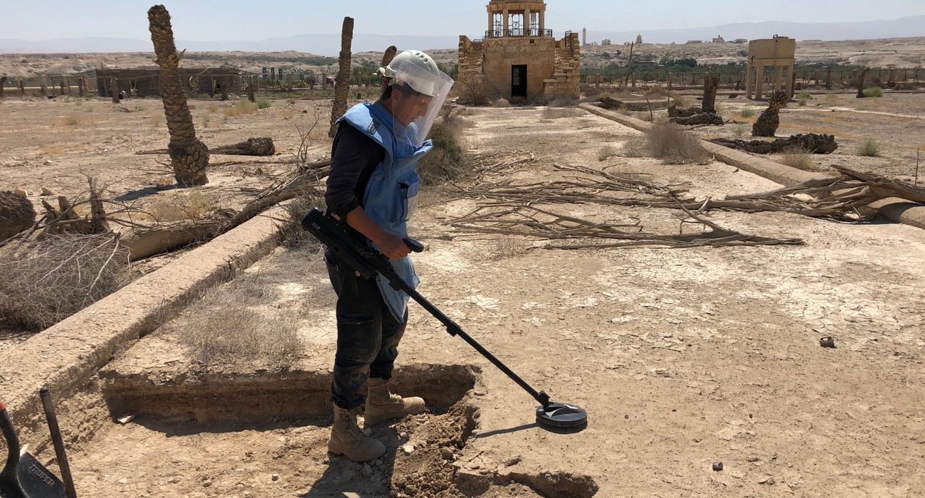 A HALO Trust deminer carefully uses a detector in the Franciscan Compound