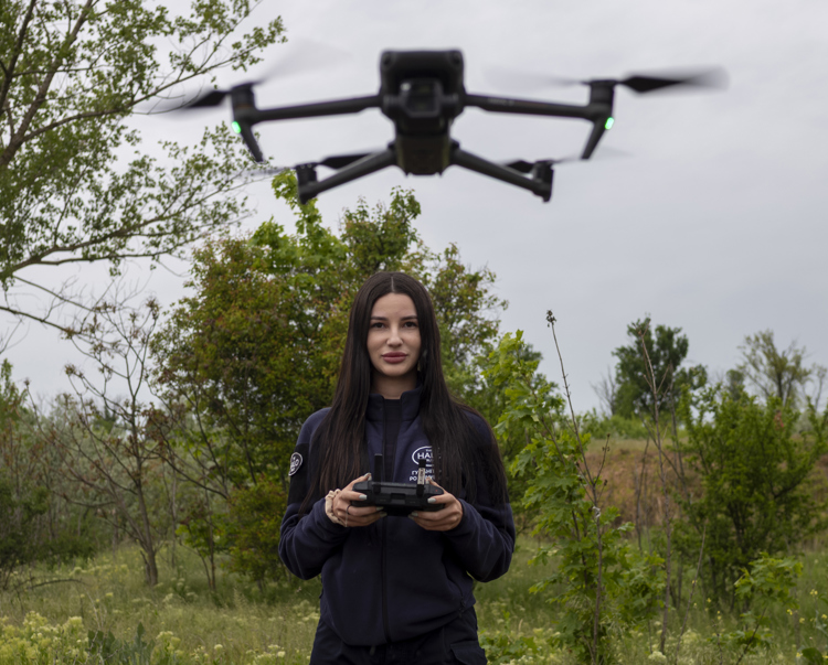 A HALO staff member controls a drone