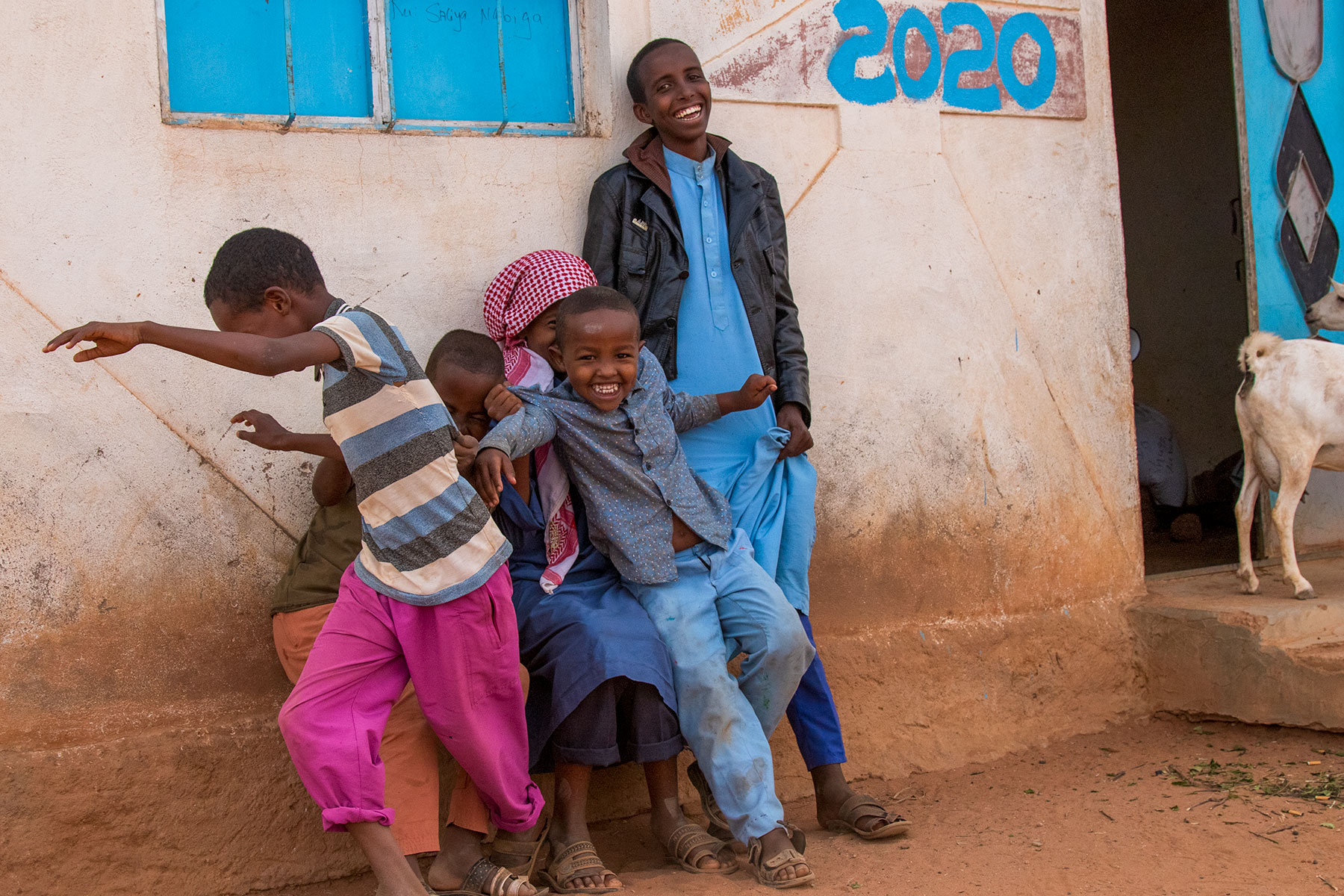 Children playing next to a wall in Somaliland