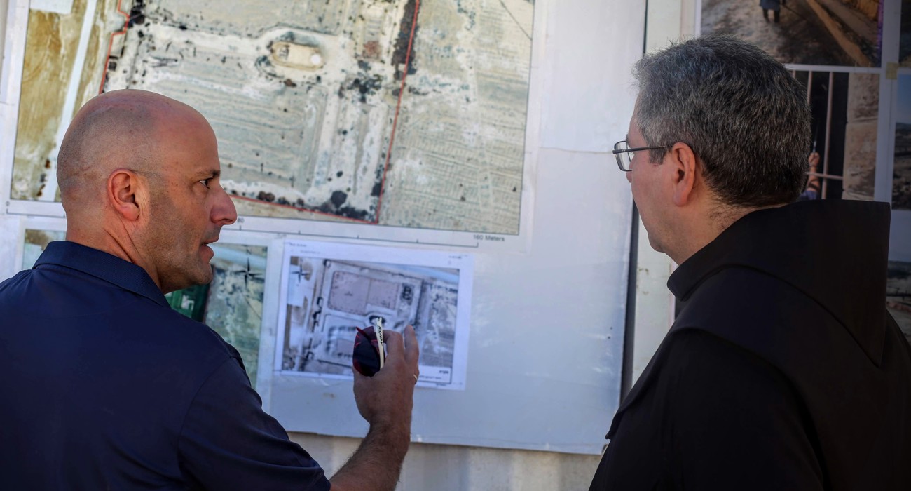The head of the Franciscan mission is shown a map of previous contamination by a HALO Trust staff member following clearance of the compound