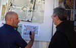 The head of the Franciscan mission is shown a map of previous contamination by a HALO Trust staff member following clearance of the compound