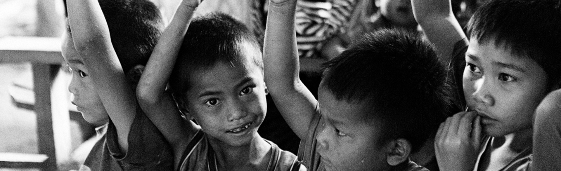 Kids in a risk education class raise their hands