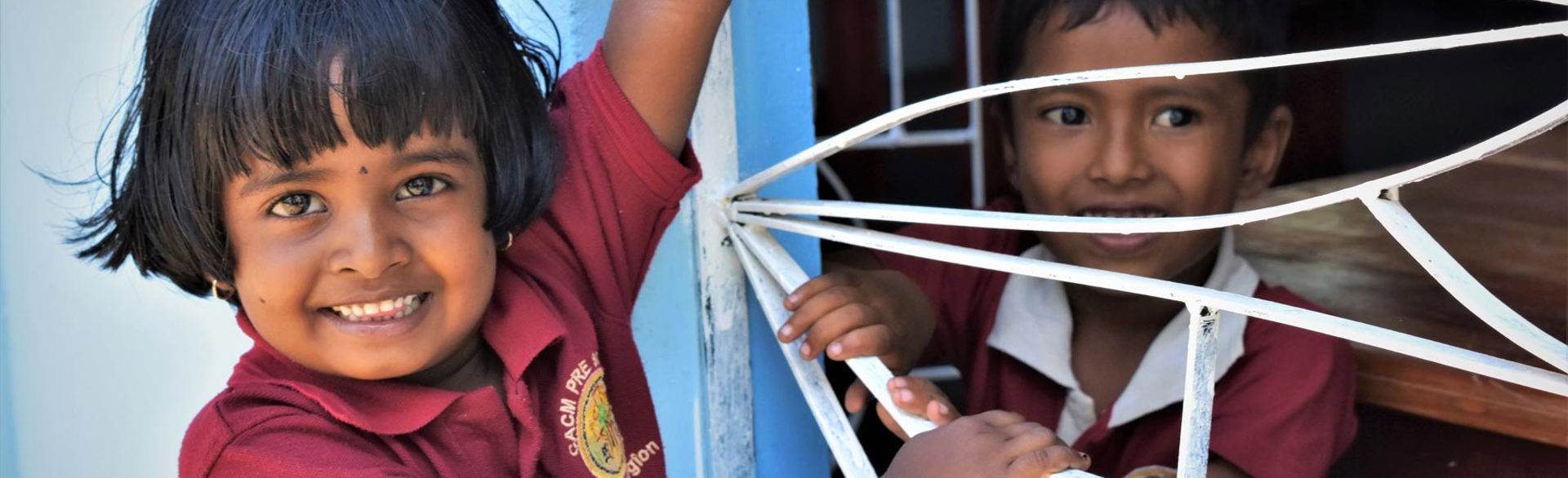 Two children smiling in a school in Sri Lanka
