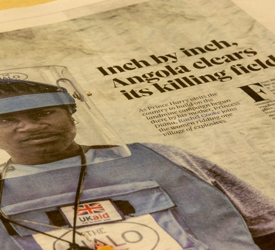 A newspaper with a photo of a HALO Trust deminer in Angola, along with a headline about Prince Harry's visit to the country
