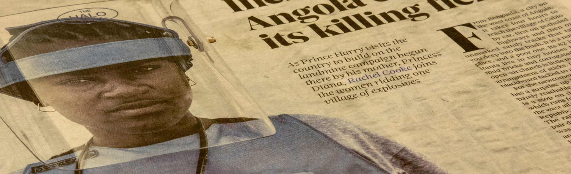 A newspaper with a photo of a HALO Trust deminer in Angola, along with a headline about Prince Harry's visit to the country