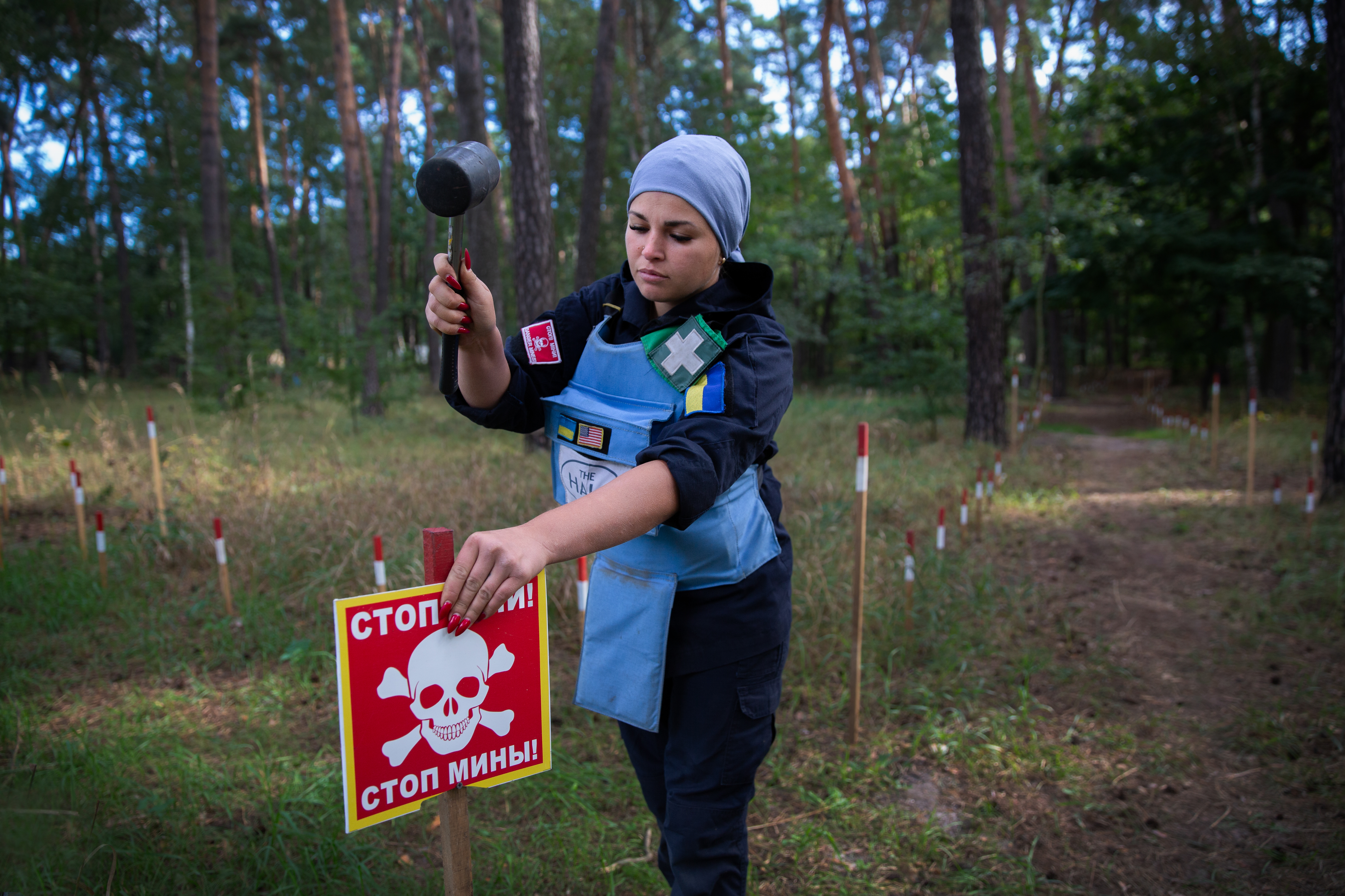 HALO deminer Karina at work putting up danger signs