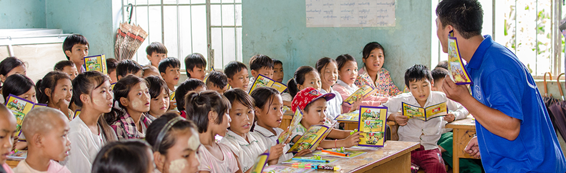 A HALO staff member gives a risk education class to children in Myanmar