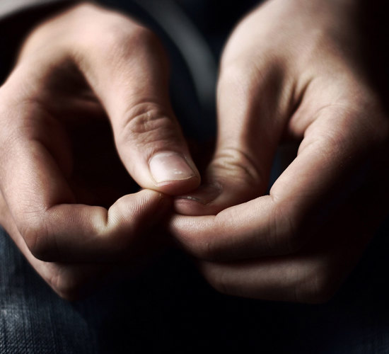 A close up shot of a person holding their thumbs together